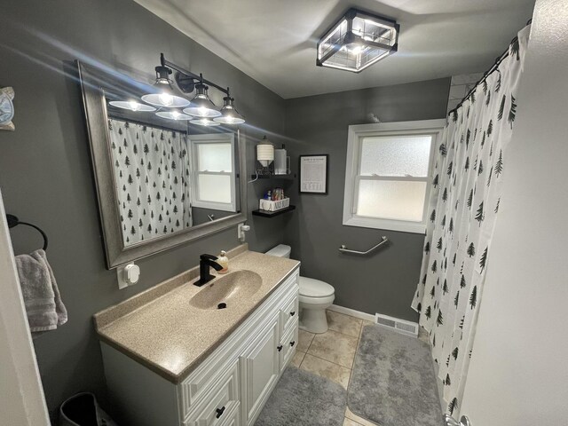 bathroom featuring tile patterned flooring, toilet, vanity, visible vents, and a shower with curtain