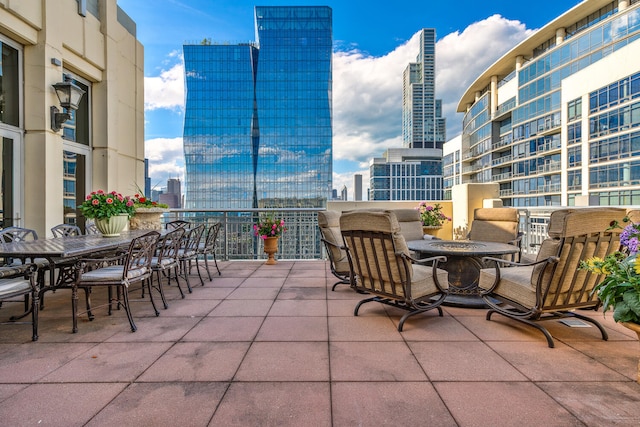 view of patio with outdoor dining area and a city view