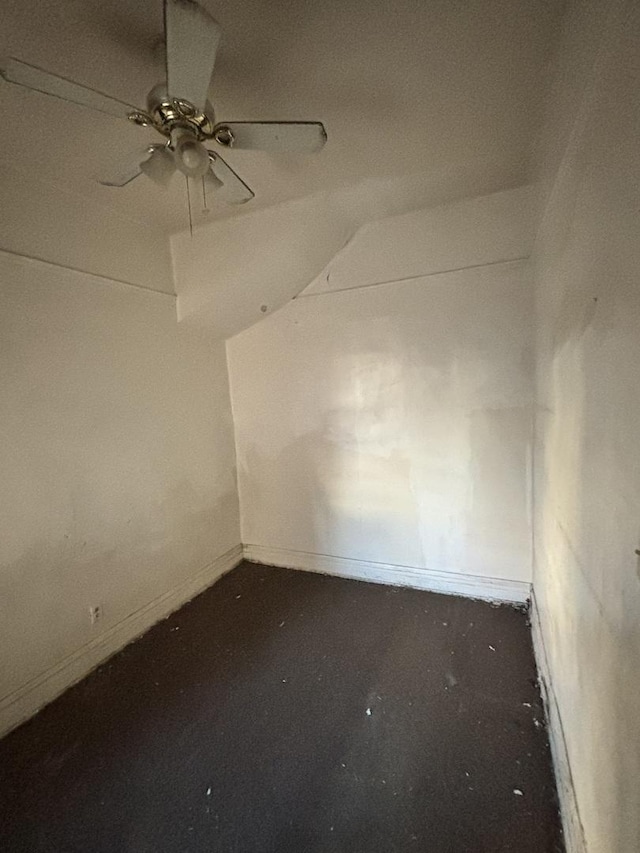 empty room featuring lofted ceiling and ceiling fan