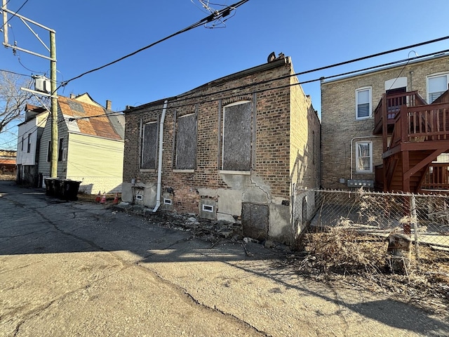 exterior space with fence and brick siding