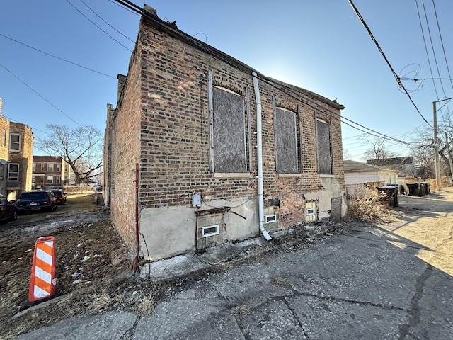 view of property exterior featuring brick siding