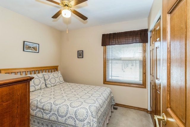 bedroom featuring ceiling fan, baseboards, and light colored carpet