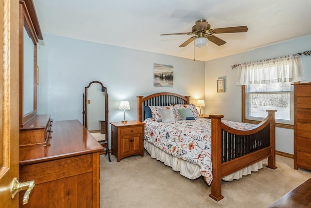 bedroom with a ceiling fan, light colored carpet, and baseboards