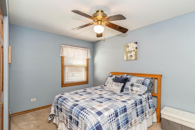 carpeted bedroom with baseboards and a ceiling fan