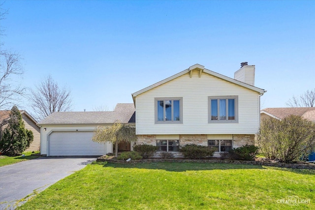 split level home featuring aphalt driveway, a front yard, stone siding, and an attached garage