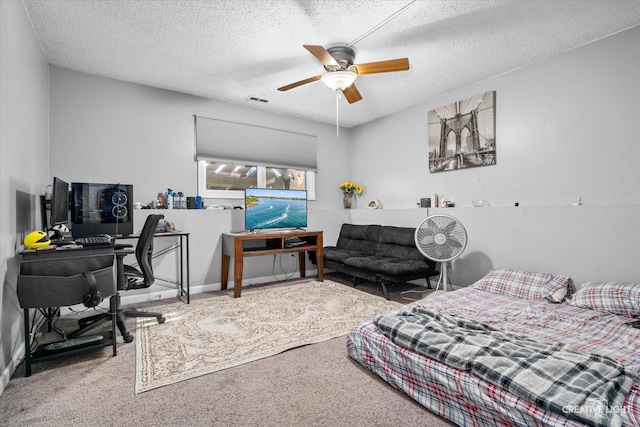 bedroom with a ceiling fan, carpet, visible vents, and a textured ceiling