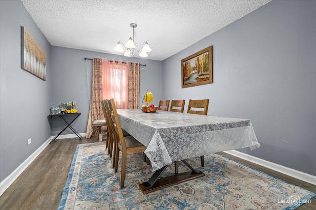 dining area with an inviting chandelier, a textured ceiling, baseboards, and dark wood-style flooring