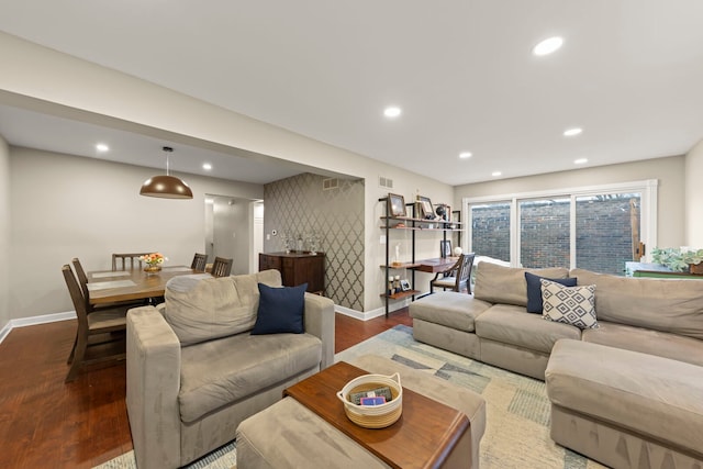 living area with visible vents, baseboards, wood finished floors, and recessed lighting