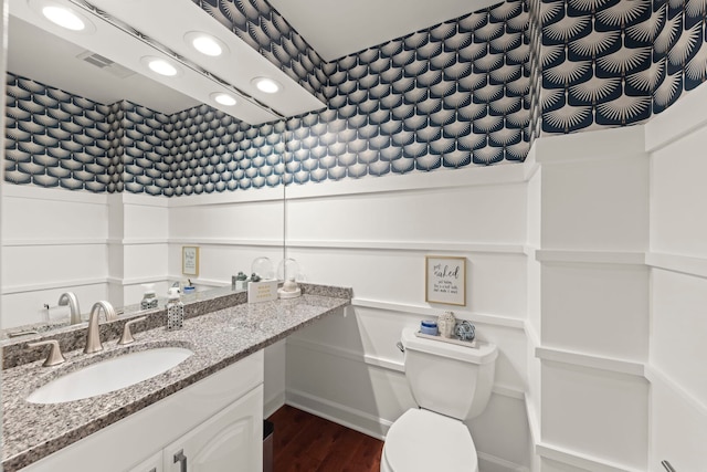 bathroom with recessed lighting, wood finished floors, and vanity