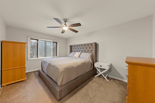 carpeted bedroom with baseboards and a ceiling fan