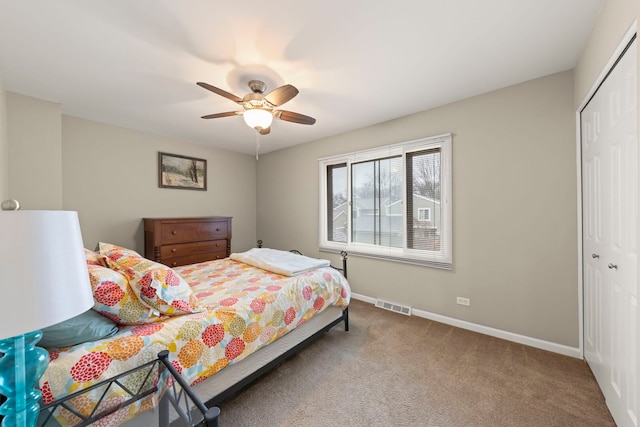 bedroom featuring carpet, a closet, visible vents, and baseboards