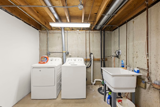 laundry room featuring a sink, laundry area, and washing machine and dryer