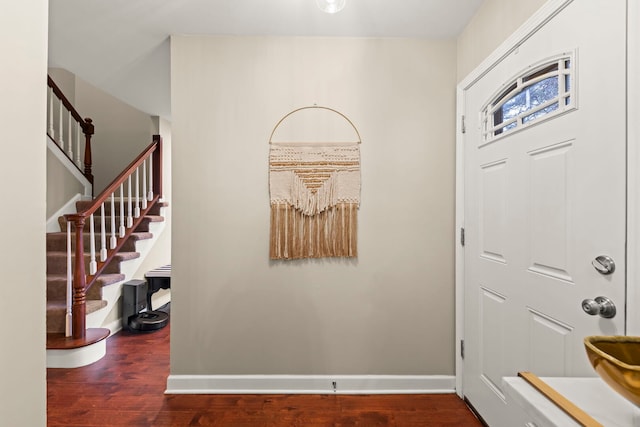 entrance foyer featuring stairway, baseboards, and wood finished floors