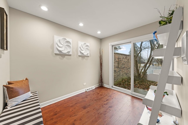 interior space with recessed lighting, wood finished floors, visible vents, and baseboards