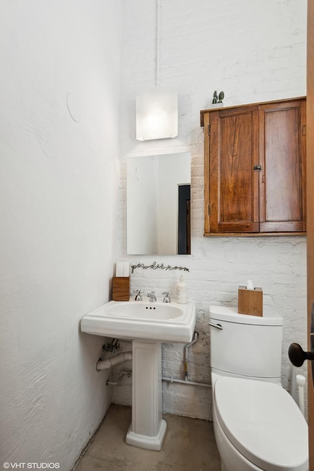 bathroom featuring toilet and unfinished concrete floors