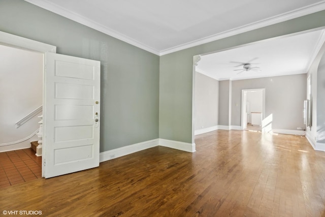 unfurnished room featuring ceiling fan, baseboards, wood finished floors, and crown molding