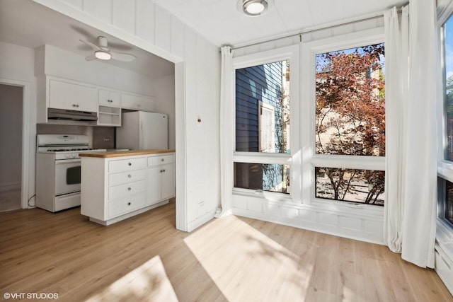 kitchen featuring light wood-style flooring, white cabinetry, wood counters, white appliances, and under cabinet range hood