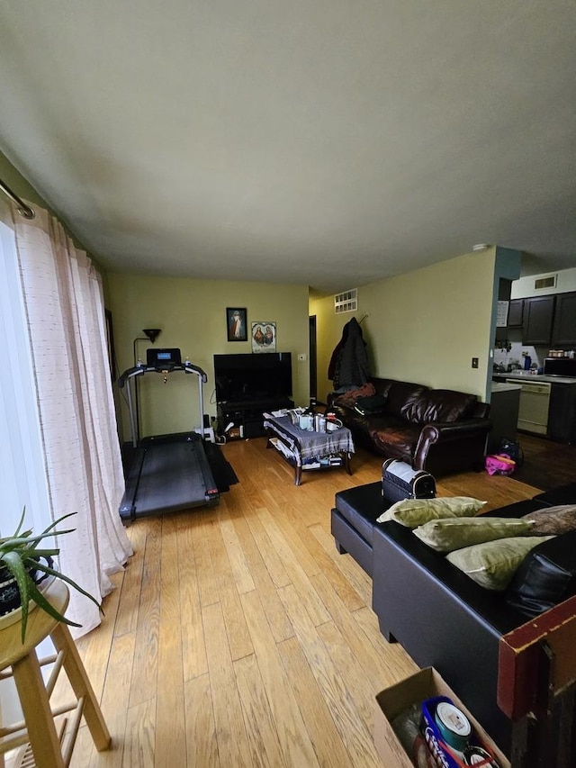 living room featuring light wood-type flooring and visible vents