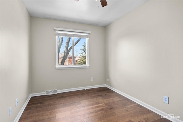 spare room with visible vents, baseboards, a ceiling fan, and dark wood-style flooring