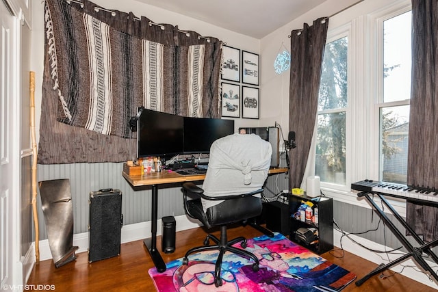 office space with wainscoting and wood finished floors