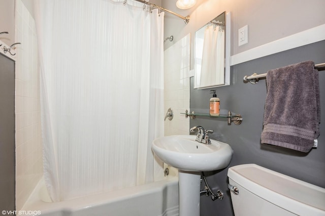 bathroom with shower / tub combo and toilet