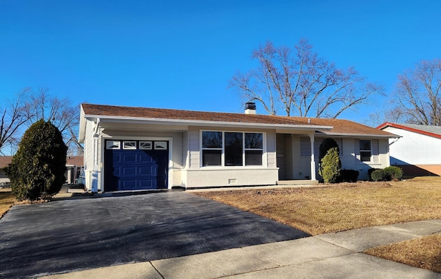 ranch-style house with driveway, a chimney, an attached garage, a front lawn, and brick siding