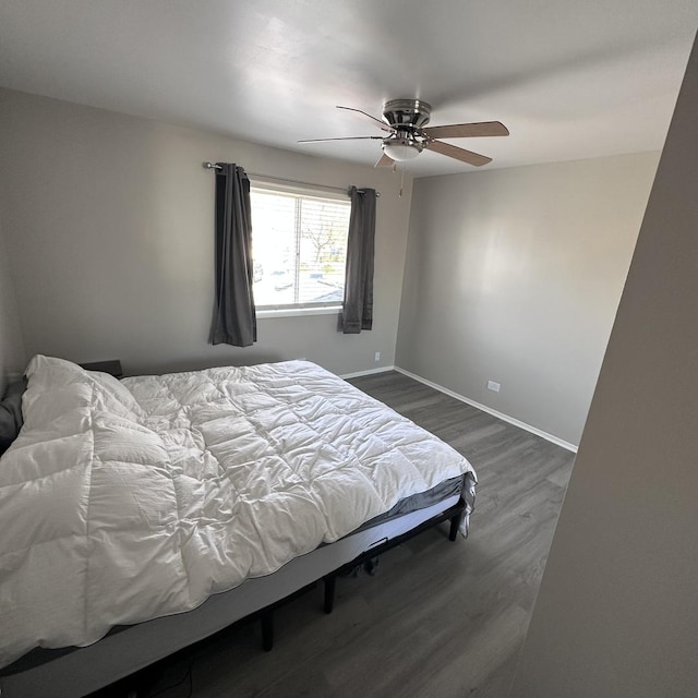 bedroom featuring ceiling fan, dark wood finished floors, and baseboards