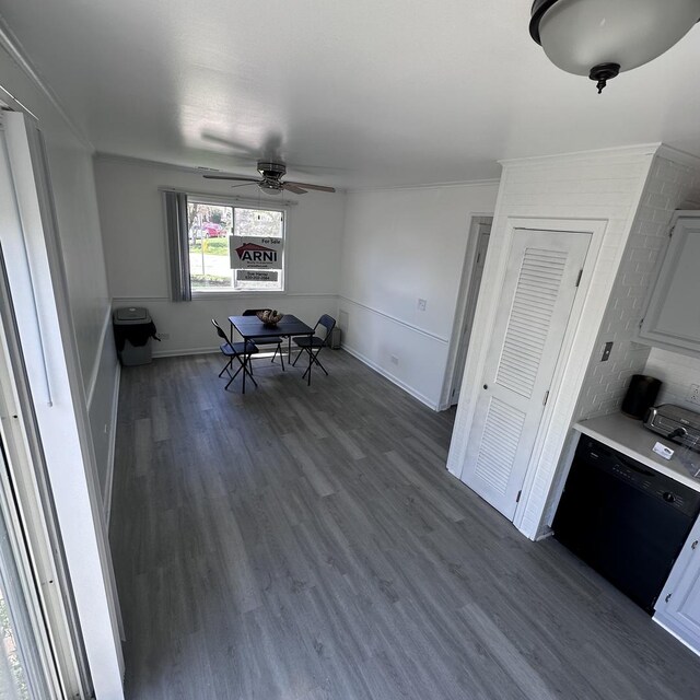 dining area featuring ceiling fan, baseboards, and dark wood finished floors