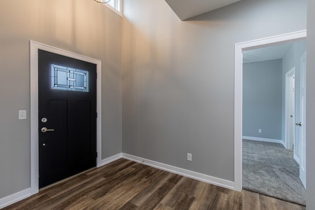 entryway with dark wood-style floors and baseboards