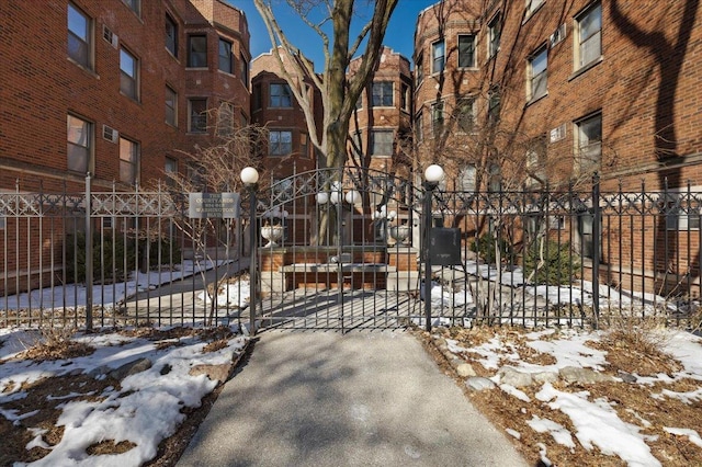 snow covered gate featuring fence