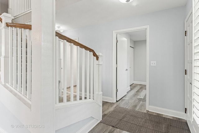 entrance foyer featuring stairs, light wood-style flooring, and baseboards