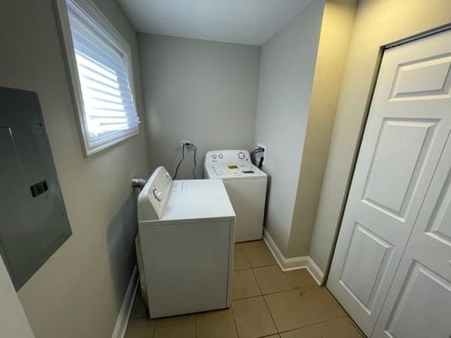 laundry area with laundry area, light tile patterned floors, baseboards, and washer hookup