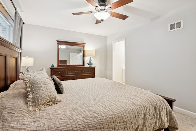 carpeted bedroom with ceiling fan, visible vents, and baseboards