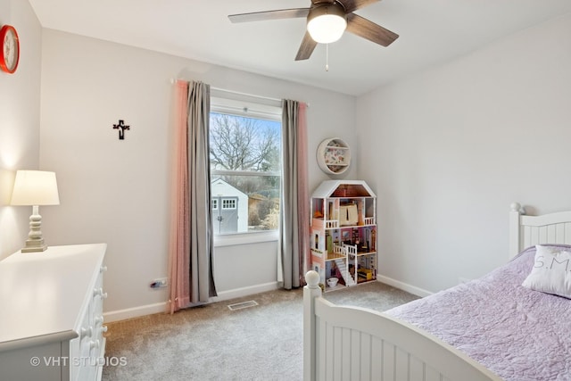 bedroom featuring baseboards, ceiling fan, visible vents, and light colored carpet