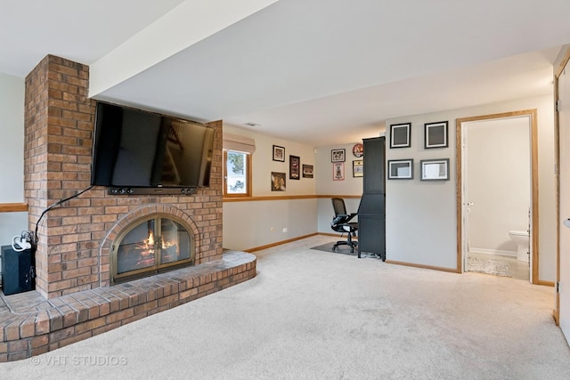 living room with a brick fireplace, carpet, and baseboards