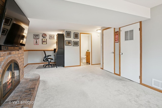 interior space featuring a brick fireplace, baseboards, visible vents, and carpet flooring