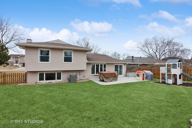 back of property with a patio area, a fenced backyard, a lawn, and a playground