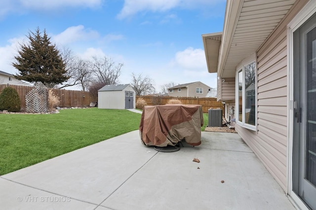 view of patio / terrace featuring a fenced backyard, a storage unit, central AC, and an outdoor structure