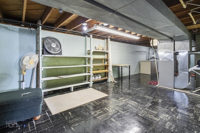 unfinished basement featuring heating unit