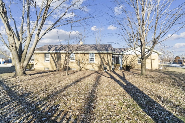 single story home featuring brick siding