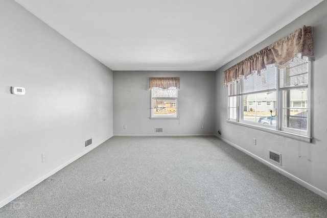 empty room with light carpet, baseboards, and visible vents