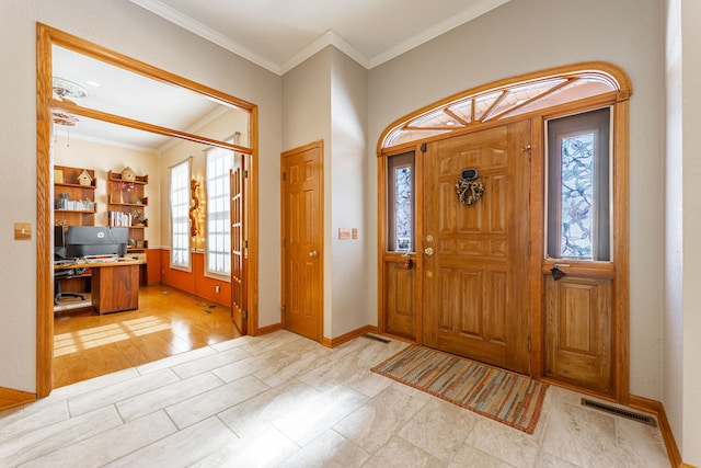 entryway with baseboards, french doors, visible vents, and crown molding