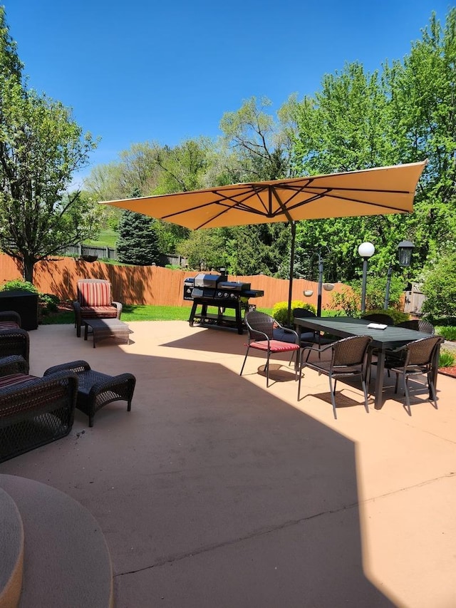 view of home's community featuring a fenced backyard, a patio, and outdoor dining space