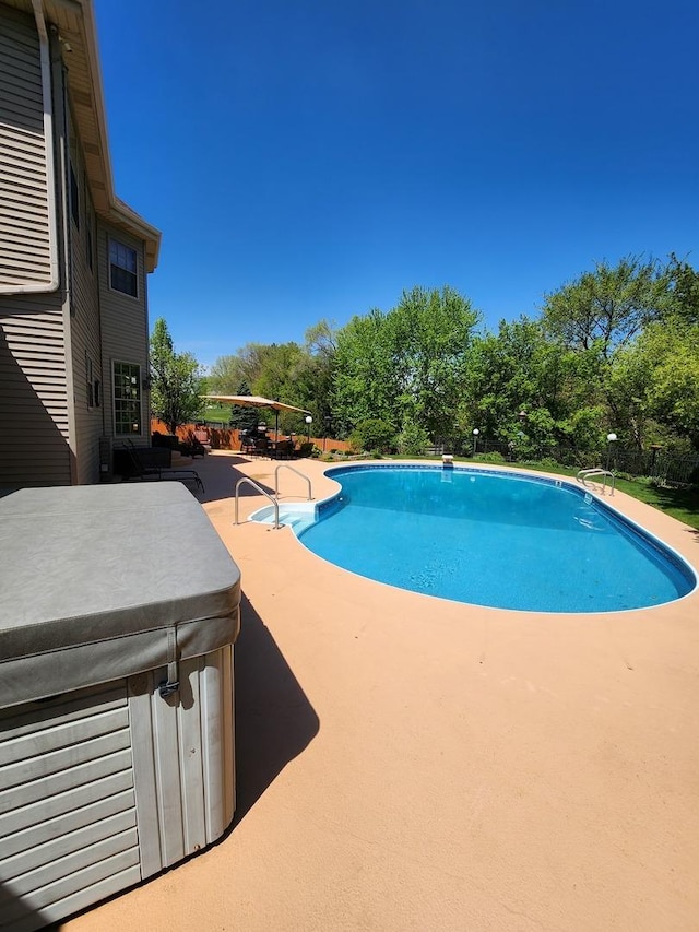 pool featuring a patio and a hot tub