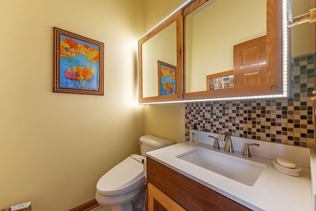 bathroom featuring backsplash, toilet, and vanity