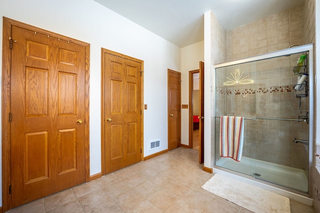 full bathroom featuring a stall shower, visible vents, and tile patterned floors