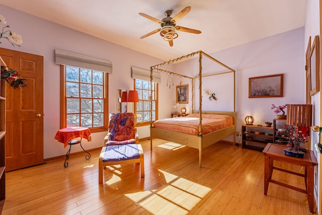 bedroom with light wood-style flooring and baseboards