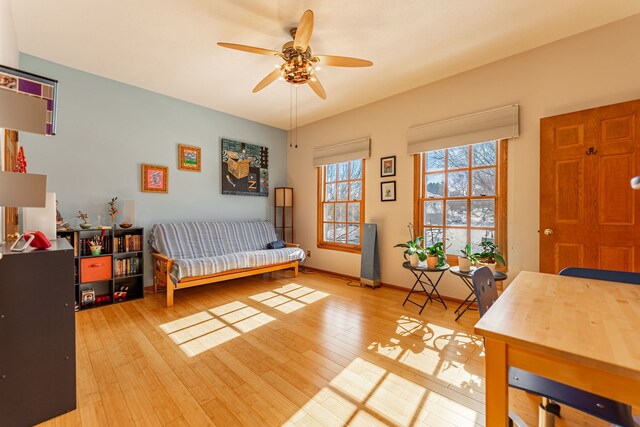 interior space with hardwood / wood-style flooring, baseboards, and a ceiling fan