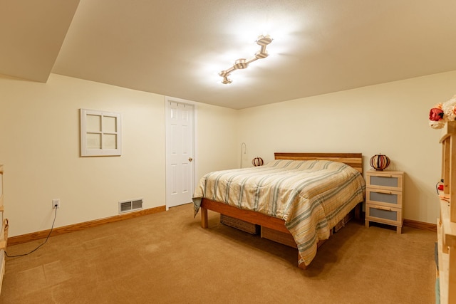 carpeted bedroom with visible vents and baseboards