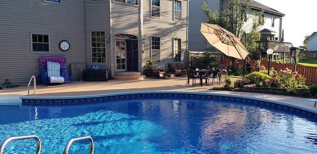 view of swimming pool featuring fence, a fenced in pool, and a patio